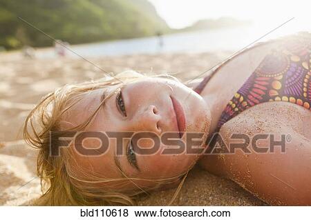 Caucasian girl laying in sand View Large Photo Image Stock Photo - Caucasian girl laying in sand. Fotosearch