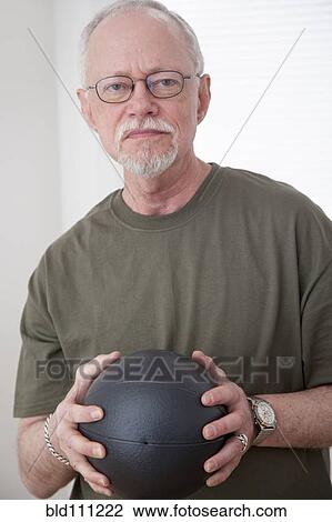 Caucasian man holding ball View Large Photo Image Stock Image - Caucasian man holding ball. Fotosearch