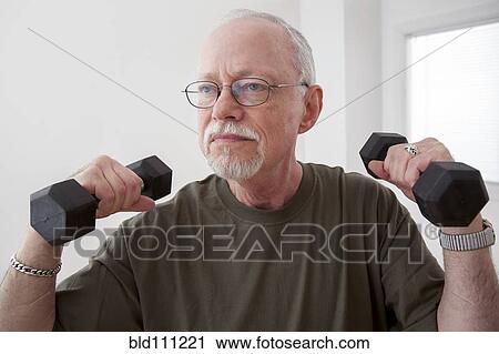 Stock Image - Caucasian man lifting weights. Fotosearch