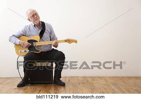 Caucasian man playing electric guitar View Large Photo Image Stock Photo - Caucasian man playing electric guitar. Fotosearch