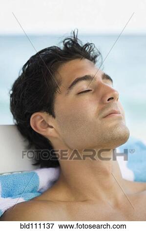 Stock Photo - Caucasian man relaxing in lawn chair. Fotosearch