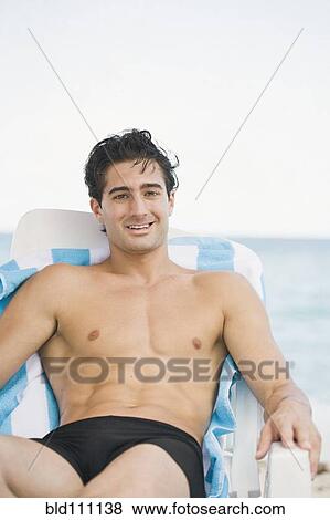 Stock Photo - Caucasian man relaxing in lawn chair. Fotosearch