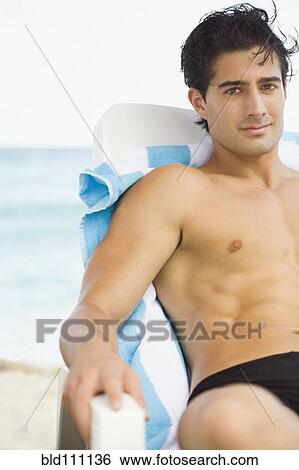 Stock Photograph - Caucasian man relaxing in lawn chair. Fotosearch