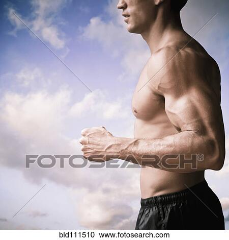 Stock Image - Caucasian man running outdoors. Fotosearch