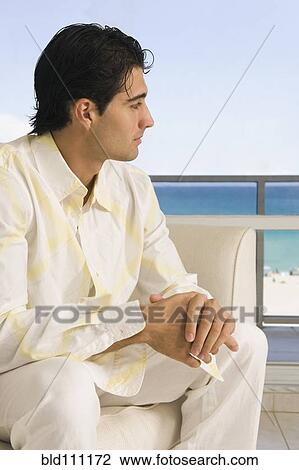 Caucasian man sitting in armchair View Large Photo Image Stock Image - Caucasian man sitting in armchair. Fotosearch