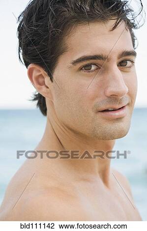 Stock Image - Caucasian man standing outdoors. Fotosearch