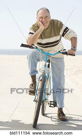 Caucasian older man sitting on bicycle View Large Photo Image Picture - Caucasian older man sitting on bicycle. Fotosearch