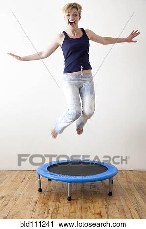Caucasian woman jumping on indoor trampoline View Large Photo Image Stock Image - Caucasian woman jumping on indoor trampoline. Fotosearch
