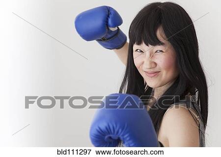 Stock Photo - Chinese boxer with raised fists. Fotosearch