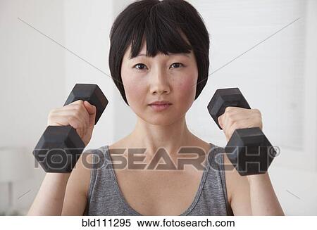 Stock Photography - Chinese woman lifting weights. Fotosearch