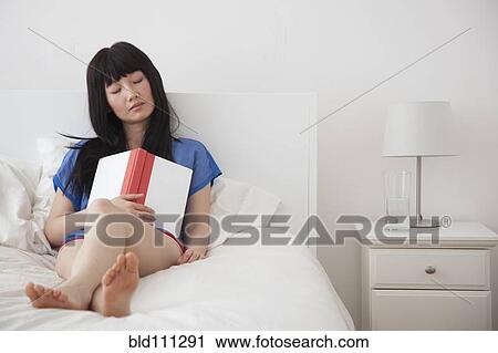 Chinese woman sleeping with book in hand View Large Photo Image Stock Image - Chinese woman sleeping with book in hand. Fotosearch