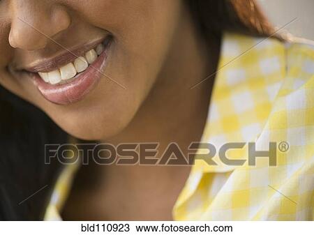 Stock Image - Close up of African American woman's smile. Fotosearch