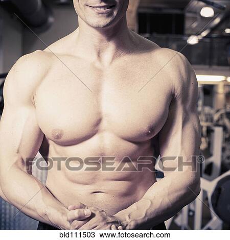 Stock Image - Close up of Caucasian man's muscular torso. Fotosearch