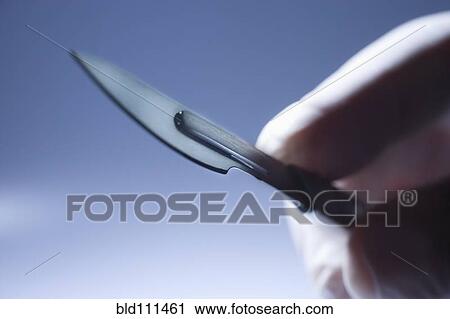 Close up of Hispanic doctor holding surgical equipment View Large Photo Image Stock Image - Close up of Hispanic doctor holding surgical equipment. Fotosearch