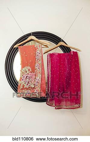 Colorful fabrics hanging by mirror View Large Photo Image Stock Photograph - Colorful fabrics hanging by mirror. Fotosearch