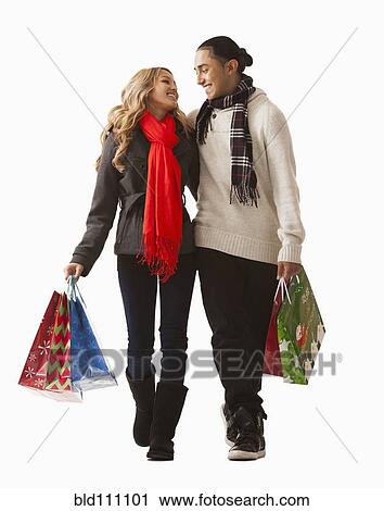 Stock Image - Couple carrying shopping bags. Fotosearch