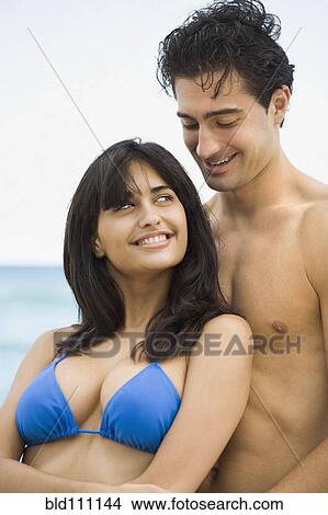 Picture - Couple hugging on beach. Fotosearch