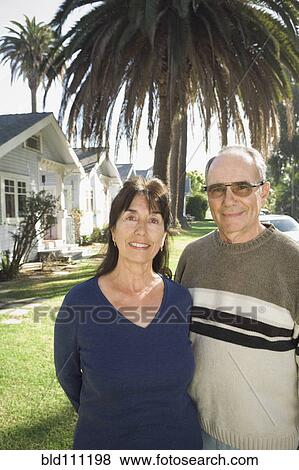Stock Photo - Couple walking on suburban street. Fotosearch