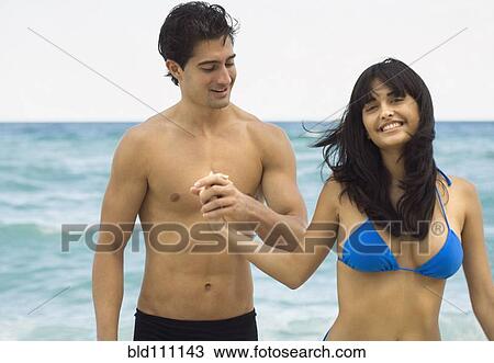 Couple walking together on beach View Large Photo Image Stock Image - Couple walking together on beach. Fotosearch