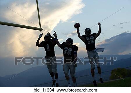 Picture - Football players cheering in game. Fotosearch