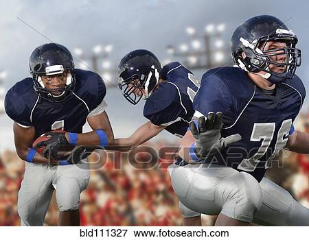 Football players passing ball View Large Photo Image Stock Photo - Football players passing ball. Fotosearch