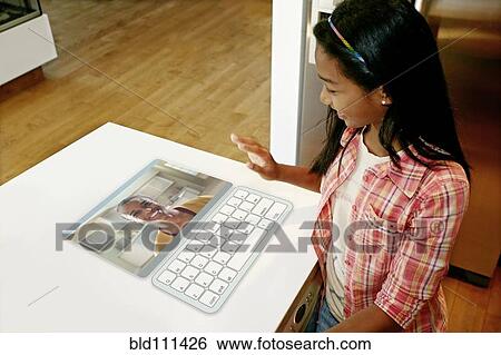 Girl waving at mother in computer in table View Large Photo Image Stock Photograph - Girl waving at mother in computer in table. Fotosearch
