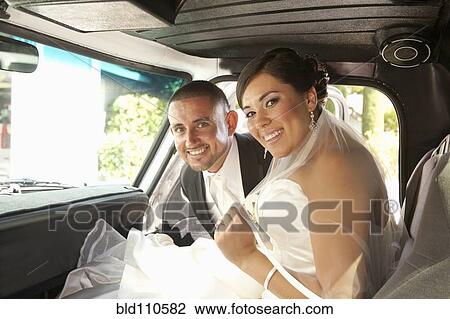Stock Image - Hispanic bride and groom in truck. Fotosearch