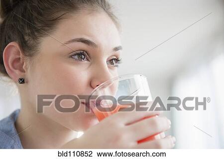 Hispanic girl drinking glass of juice View Large Photo Image Stock Image - Hispanic girl drinking glass of juice. Fotosearch