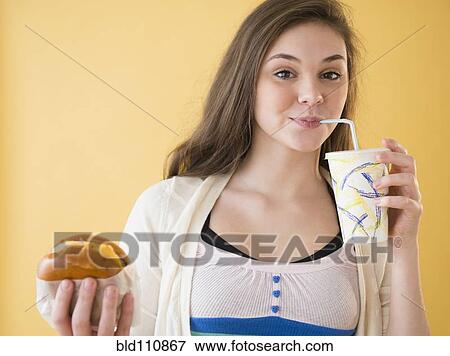 Hispanic girl having fast food View Large Photo Image Stock Photo - Hispanic girl having fast food. Fotosearch