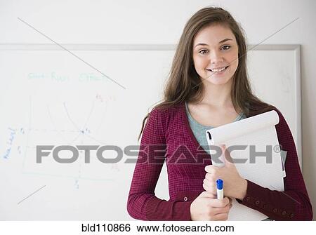 Stock Photograph - Hispanic girl holding notepad. Fotosearch