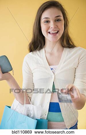 Hispanic girl paying with credit card View Large Photo Image Stock Photo - Hispanic girl paying with credit card. Fotosearch