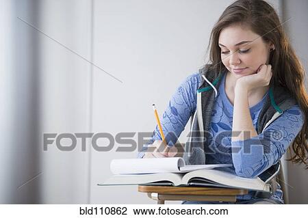 Hispanic girl studying at desk View Large Photo Image Stock Image - Hispanic girl studying at desk. Fotosearch
