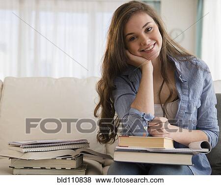 Hispanic girl studying on sofa View Large Photo Image Stock Photo - Hispanic girl studying on sofa. Fotosearch