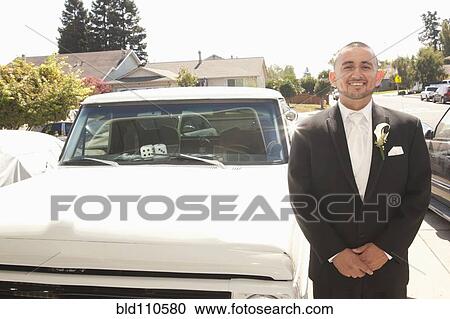Hispanic groom standing next to truck View Large Photo Image Stock Image - Hispanic groom standing next to truck. Fotosearch