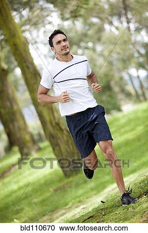 Stock Image - Hispanic man jogging. Fotosearch
