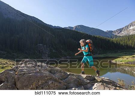 Hispanic woman hiking on boulder View Large Photo Image Stock Photography - Hispanic woman hiking on boulder. Fotosearch