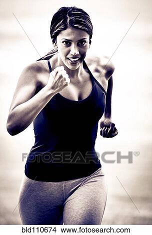 Picture - Hispanic woman running. Fotosearch