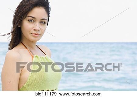 Hispanic woman standing on beach View Large Photo Image Stock Photo - Hispanic woman standing on beach. Fotosearch