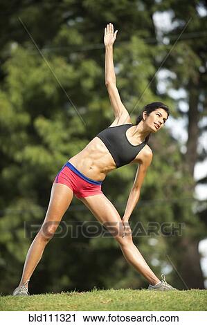 Hispanic woman stretching in rural field View Large Photo Image Stock Image - Hispanic woman stretching in rural field. Fotosearch
