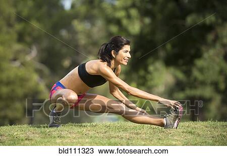 Hispanic woman stretching in rural field View Large Photo Image Stock Image - Hispanic woman stretching in rural field. Fotosearch