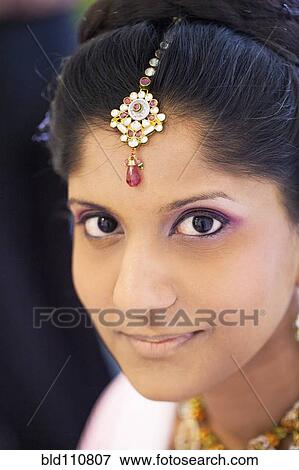 Stock Photo - Indian bride wearing head jewelry. Fotosearch