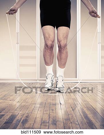 Man jumping rope indoors View Large Photo Image Stock Photo - Man jumping rope indoors. Fotosearch