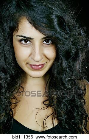 Stock Photograph - Middle Eastern woman smiling. Fotosearch