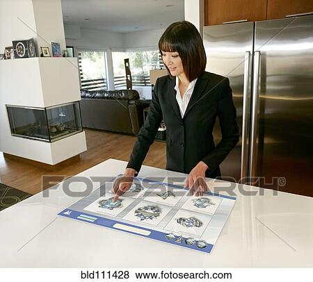 Stock Photo - Mixed race businesswoman using computer in table. Fotosearch