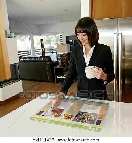 Stock Photo - Mixed race businesswoman using computer in table. Fotosearch
