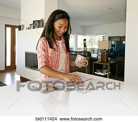 Mixed race girl using computer in table View Large Photo Image Picture - Mixed race girl using computer in table. Fotosearch