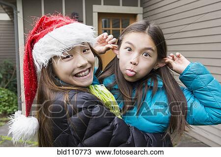 Stock Image - Mixed race girls making faces. Fotosearch