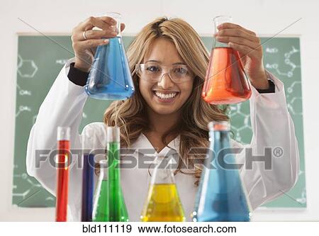 Stock Photo - Mixed race student working in chemistry lab. Fotosearch