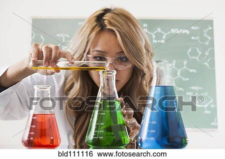Stock Photograph - Mixed race student working in chemistry lab. Fotosearch