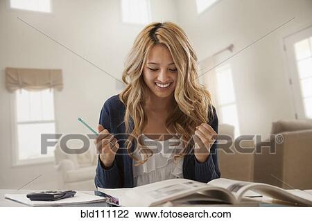 Mixed race woman cheering and studying View Large Photo Image Stock Image - Mixed race woman cheering and studying. Fotosearch